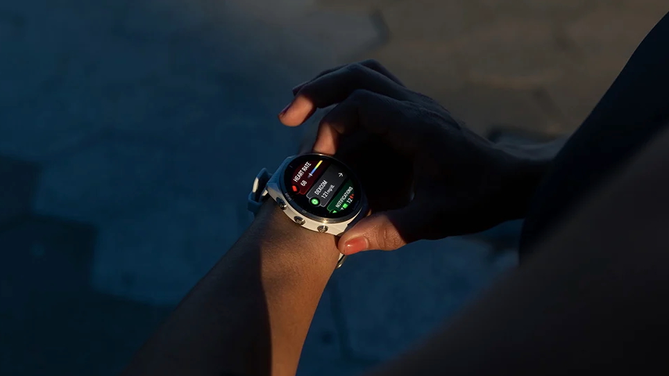 A photo of a person wearing a Garmin watch, the screen showing various widgets including a &quot;Dexcom&quot; one with &quot;121 mg/dl&quot; showing.