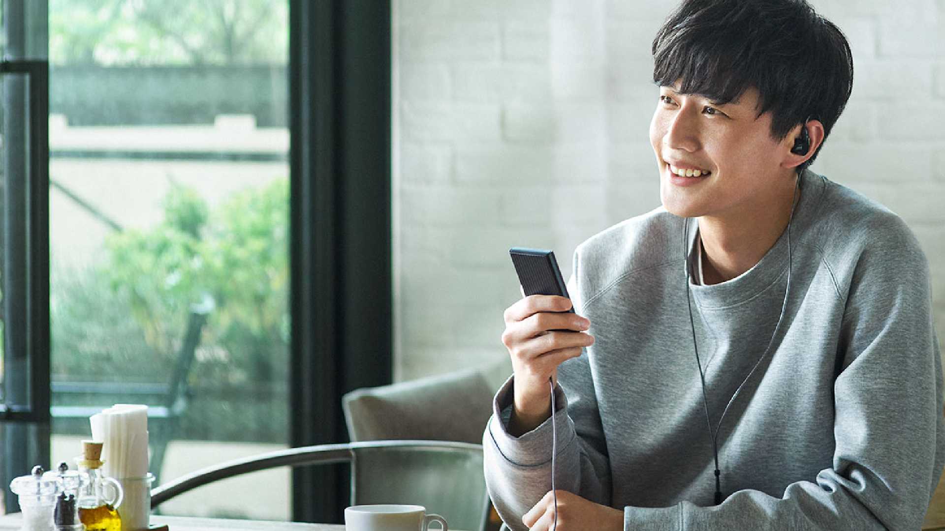 A person using the Sony NW-A306 audio player