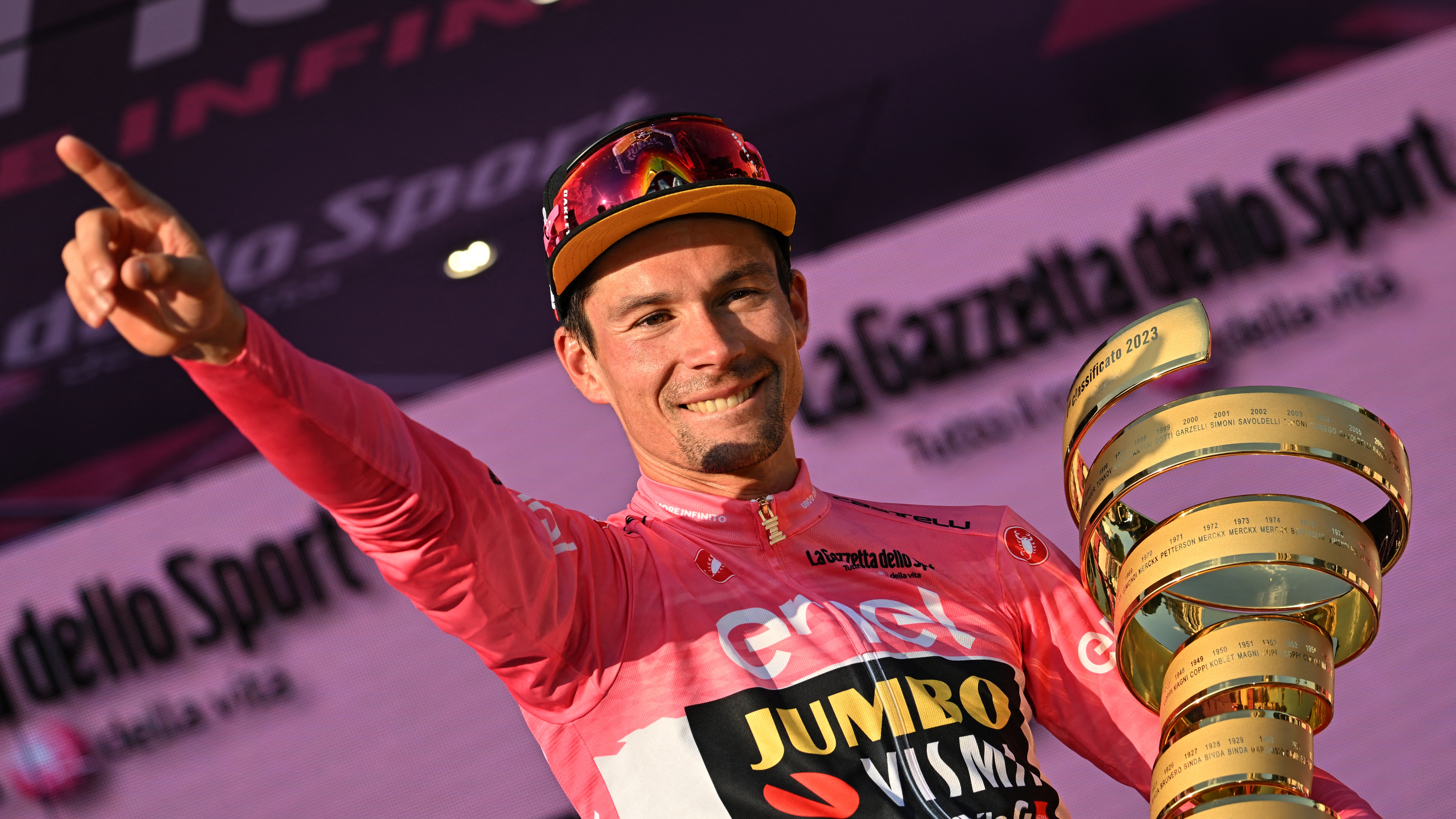 Jumbo-Visma&#039;s Slovenian rider Primoz Roglic celebrates on the podium with the race&#039;s winner&#039;s &quot;Trofeo Senza Fine&quot; (Endless Trophy) after winning the Giro d&#039;Italia cycling race in Rome (Photo by ALBERTO PIZZOLI/AFP via Getty Images)