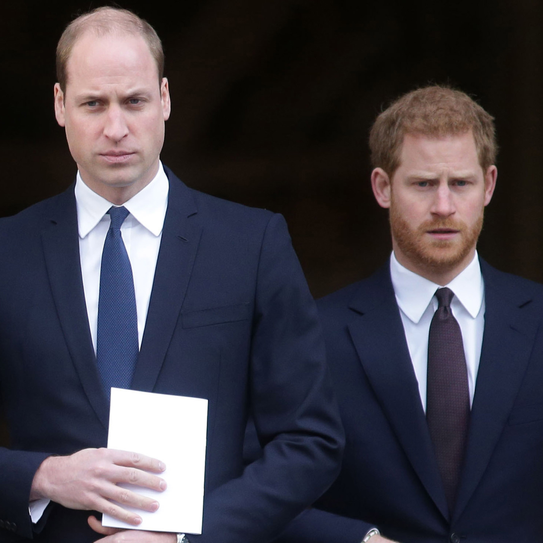 Prince William and Prince Harry both wear white shirts with navy suits