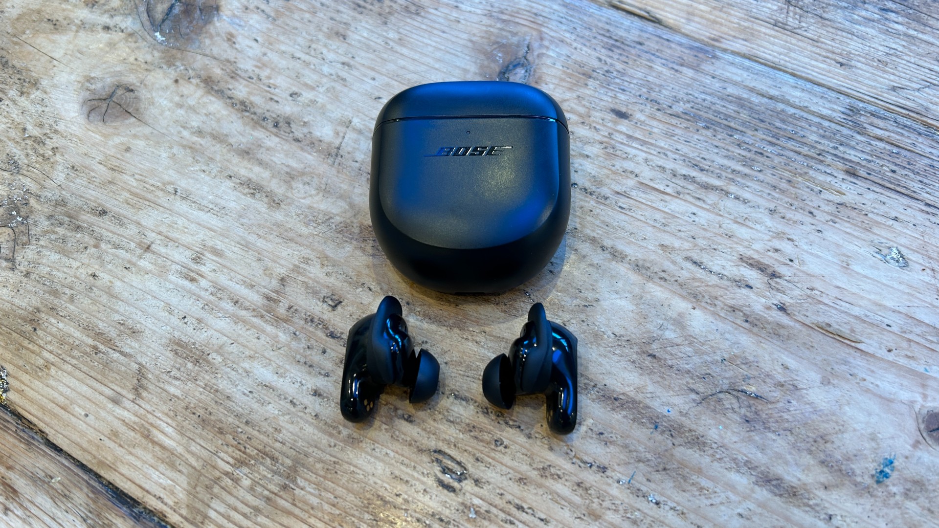 Bose QuietComfort Earbuds II next to case