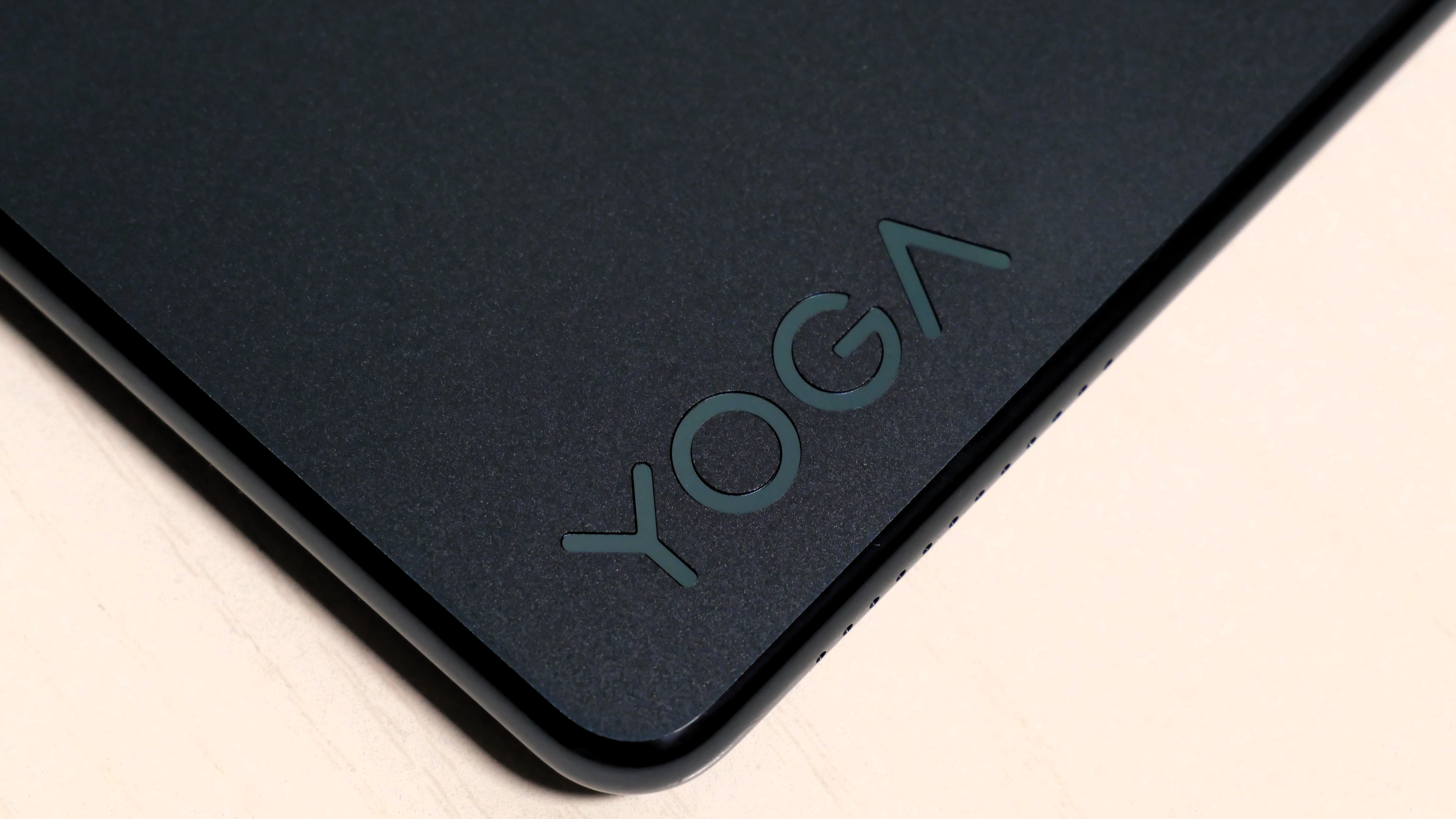 Lenovo Yoga 9i 2-in-1 Aura Edition laying flat on a table, highlighting the Yoga logo.