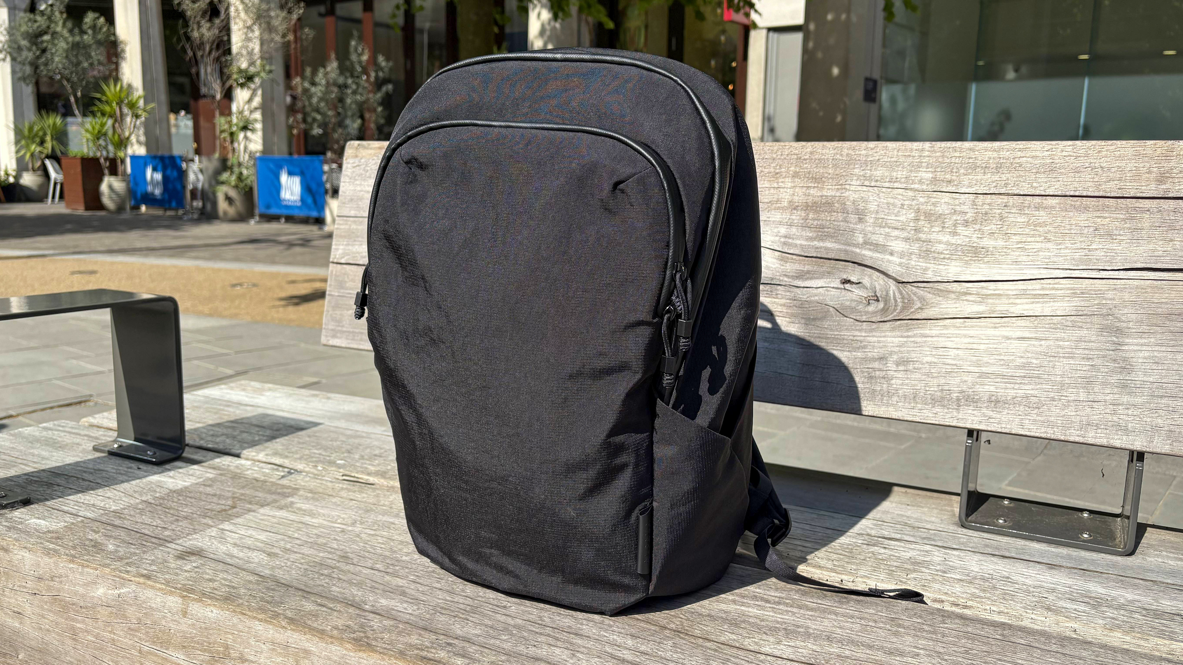 Alpaka Bravo Backpack outside sitting on bench 
