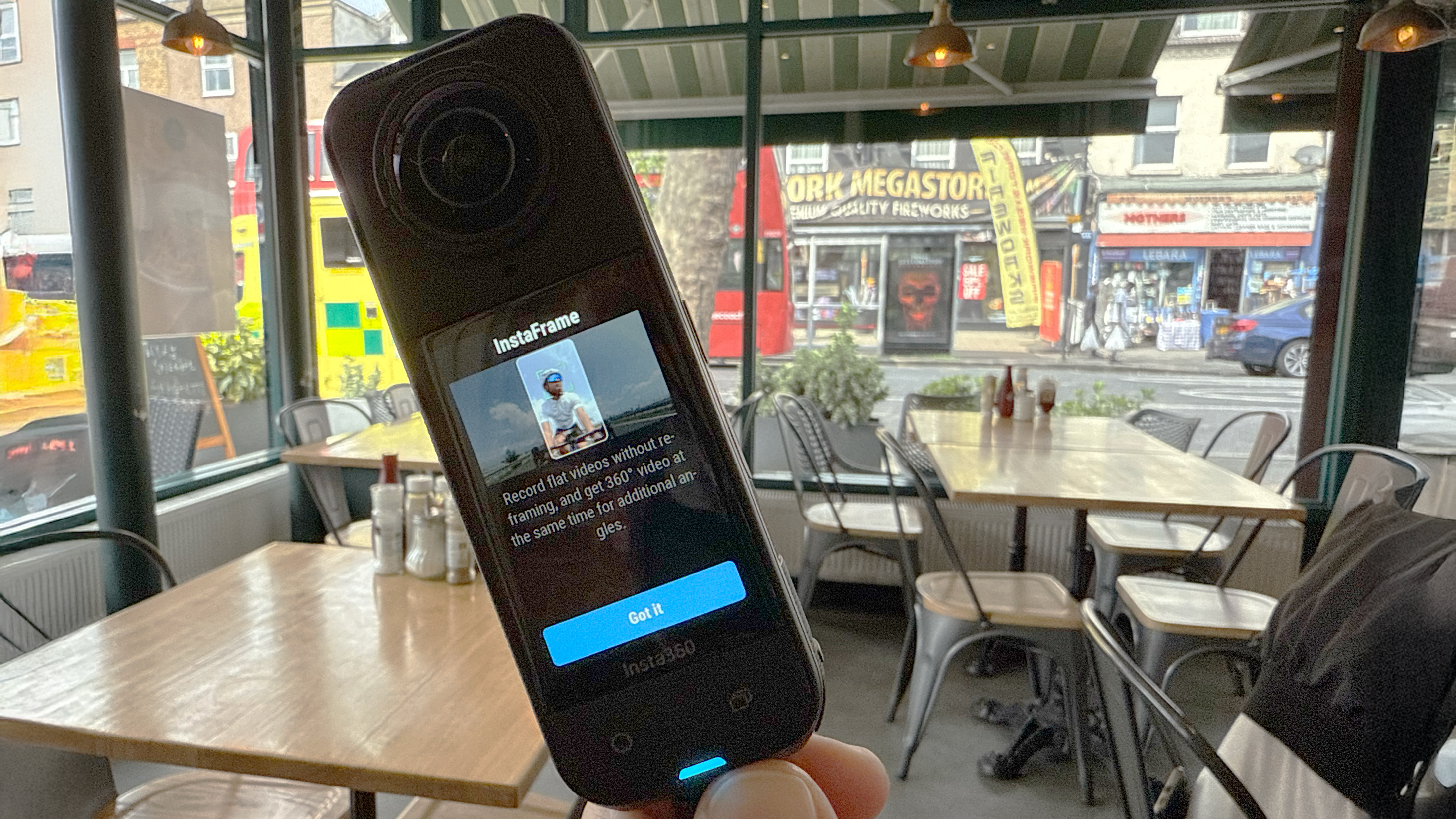 Insta360 X5 in hand showing InstaFrame tooltip on screen