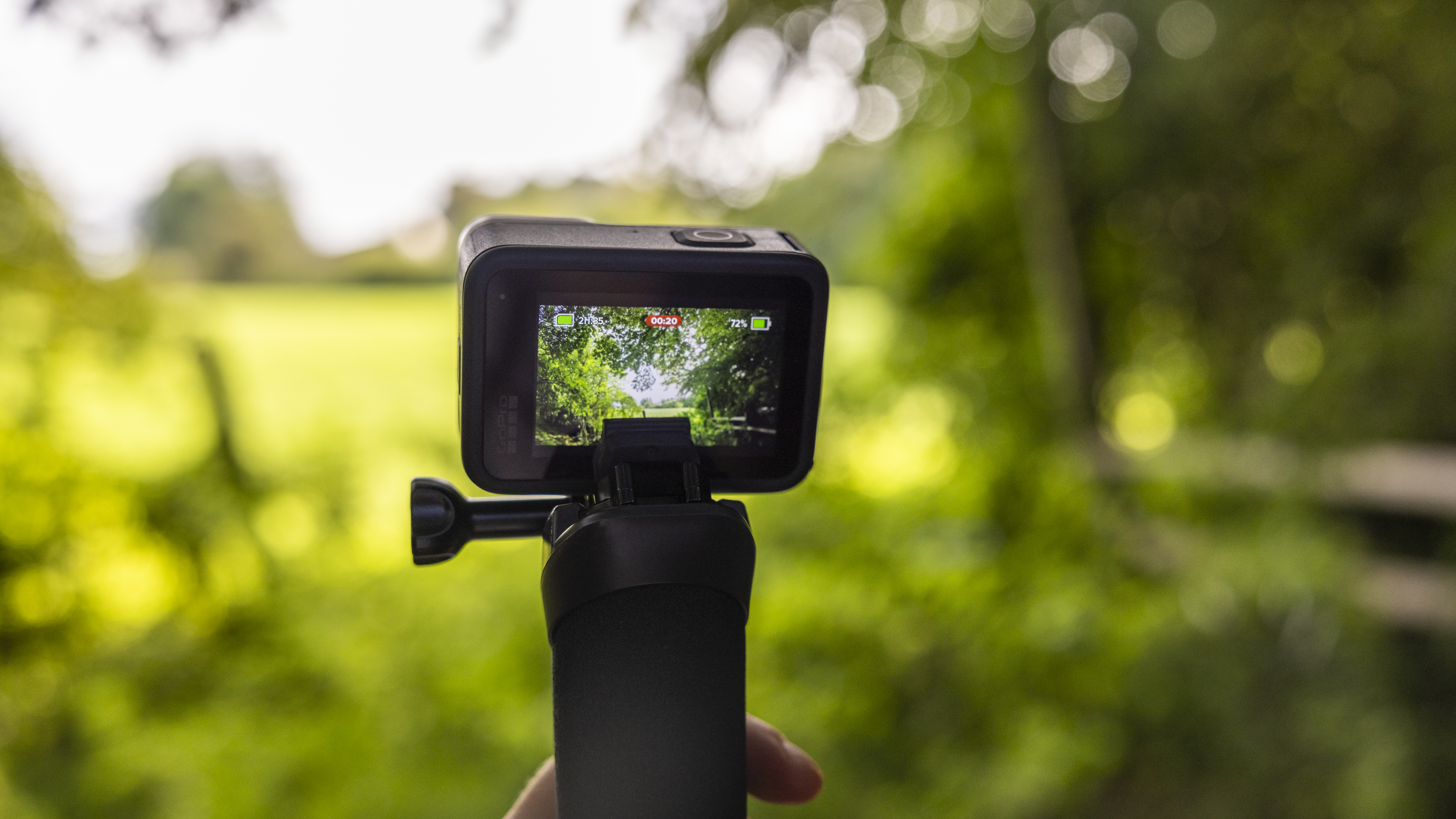 A GoPro Hero 10 Black on a floaty handler in a forest