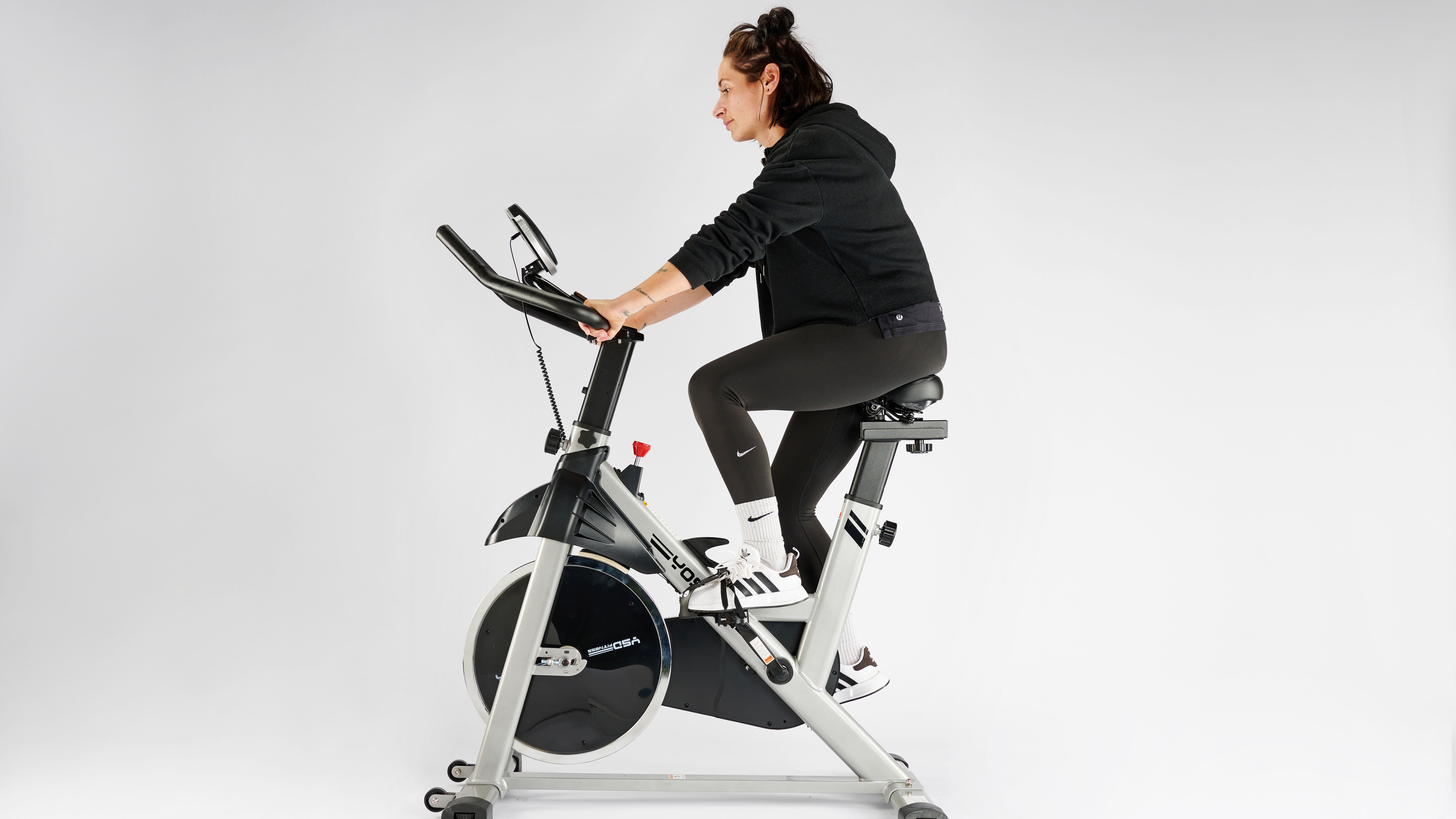 Yosuda exercise bike being ridden by Sam Hopes, resident fitness writer at Live Science