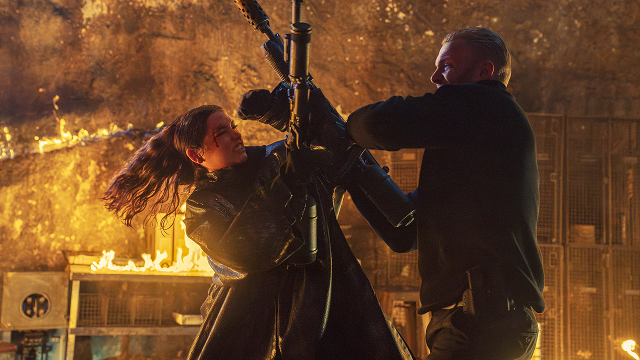 Eve Macarro fights a foe as they both wield flamethrowers in From the World of John Wick: Ballerina