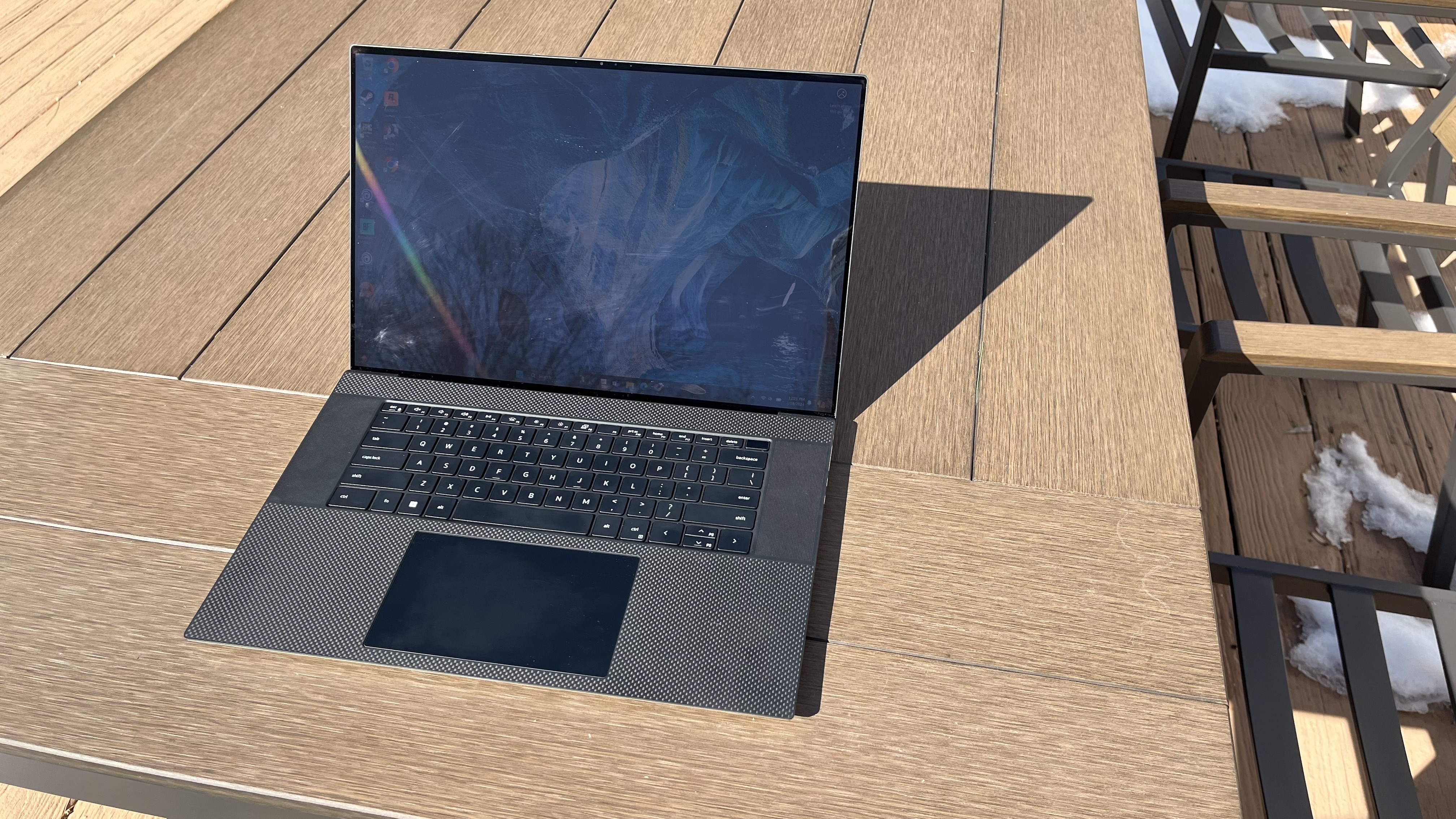 Dell XPS 17 laptop in use on a wooden desk