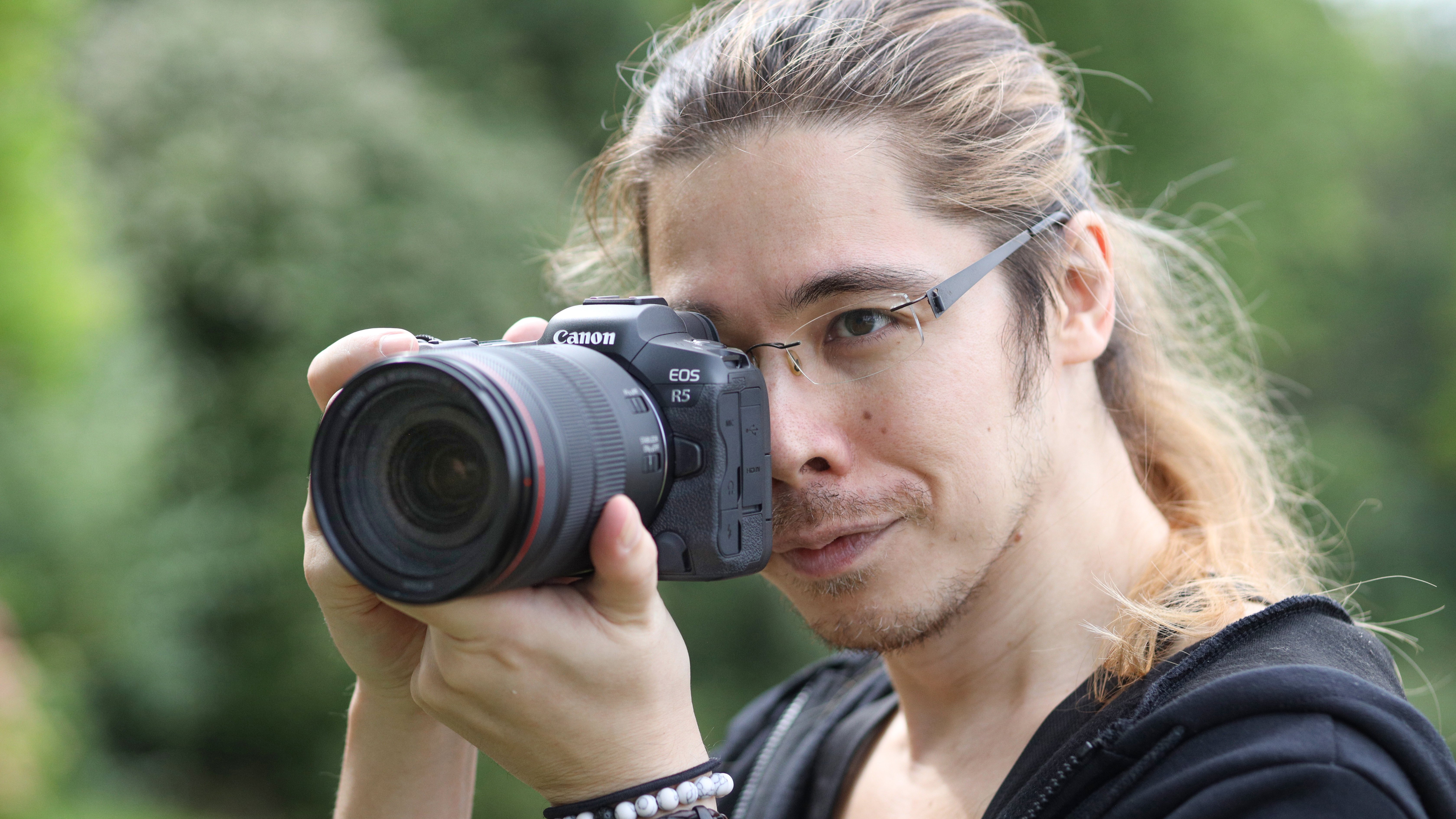 Canon EOS R5 being held by a photographer outdoors