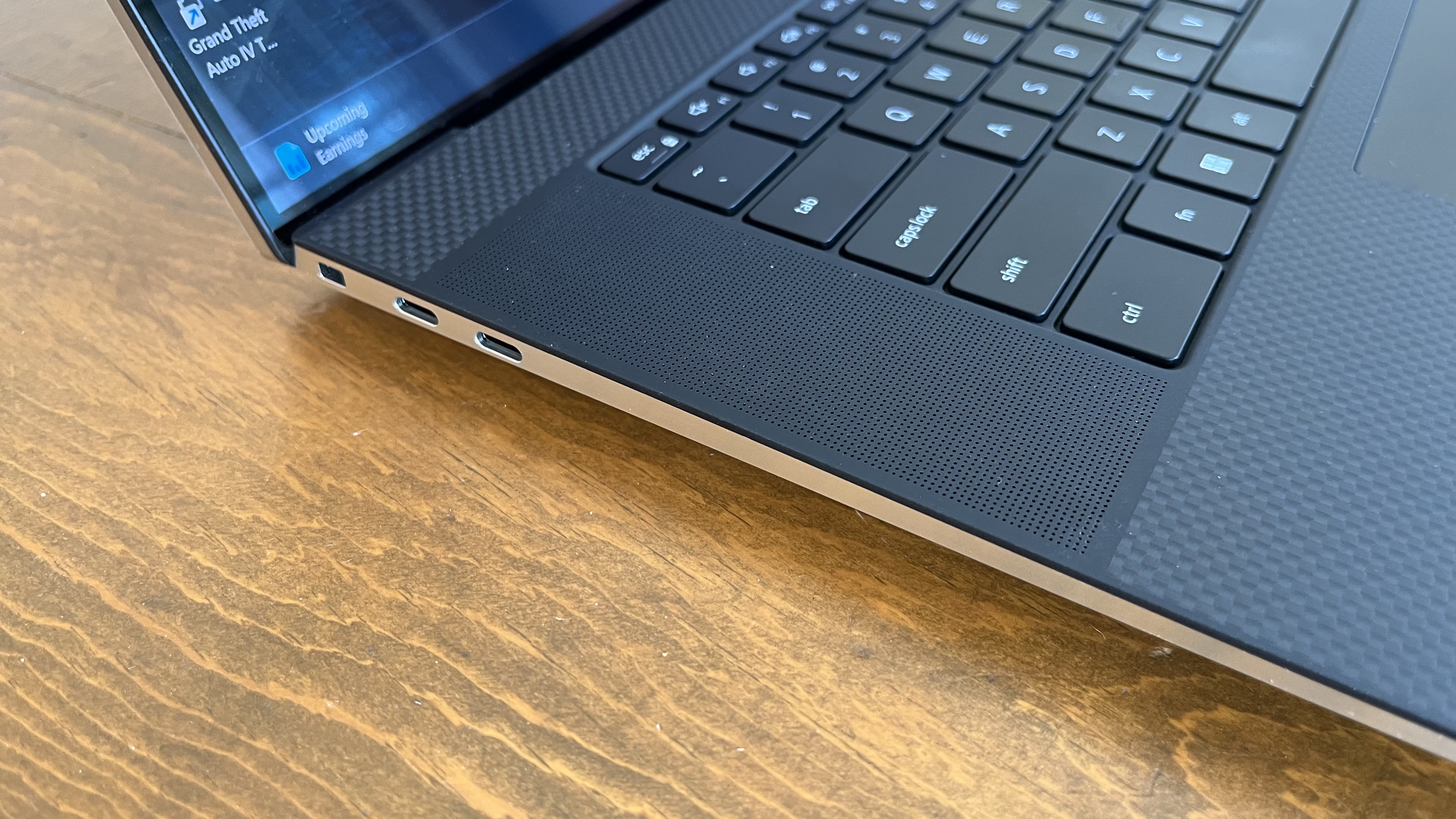 Dell XPS 17 laptop in use on a wooden desk