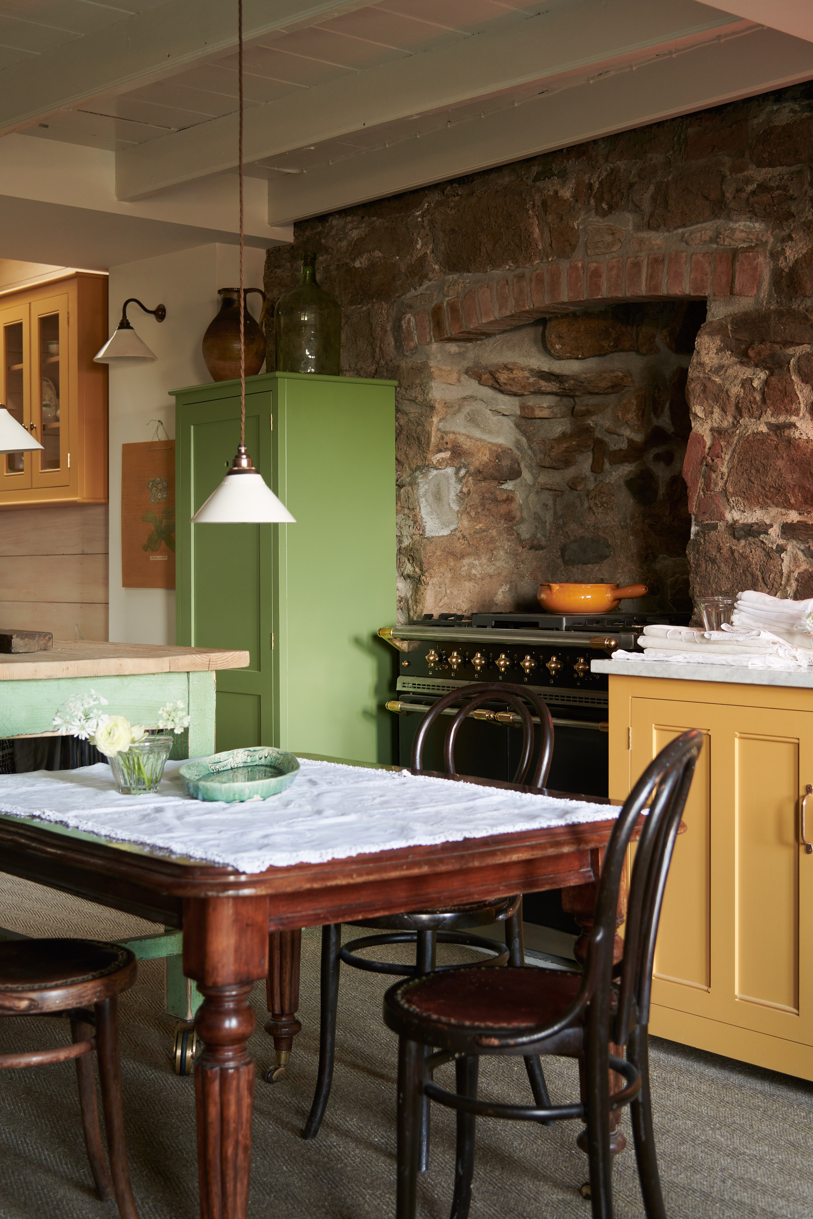 classic dark wooden table and chairs with low hanging light