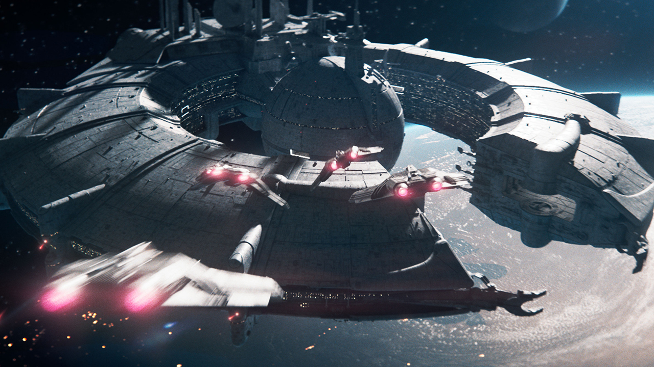 A giant C-shaped spaceship with a large globe in the middle. Four smaller spaceships are flying towards it. In the background you can see the darkness of space and lots of stars.