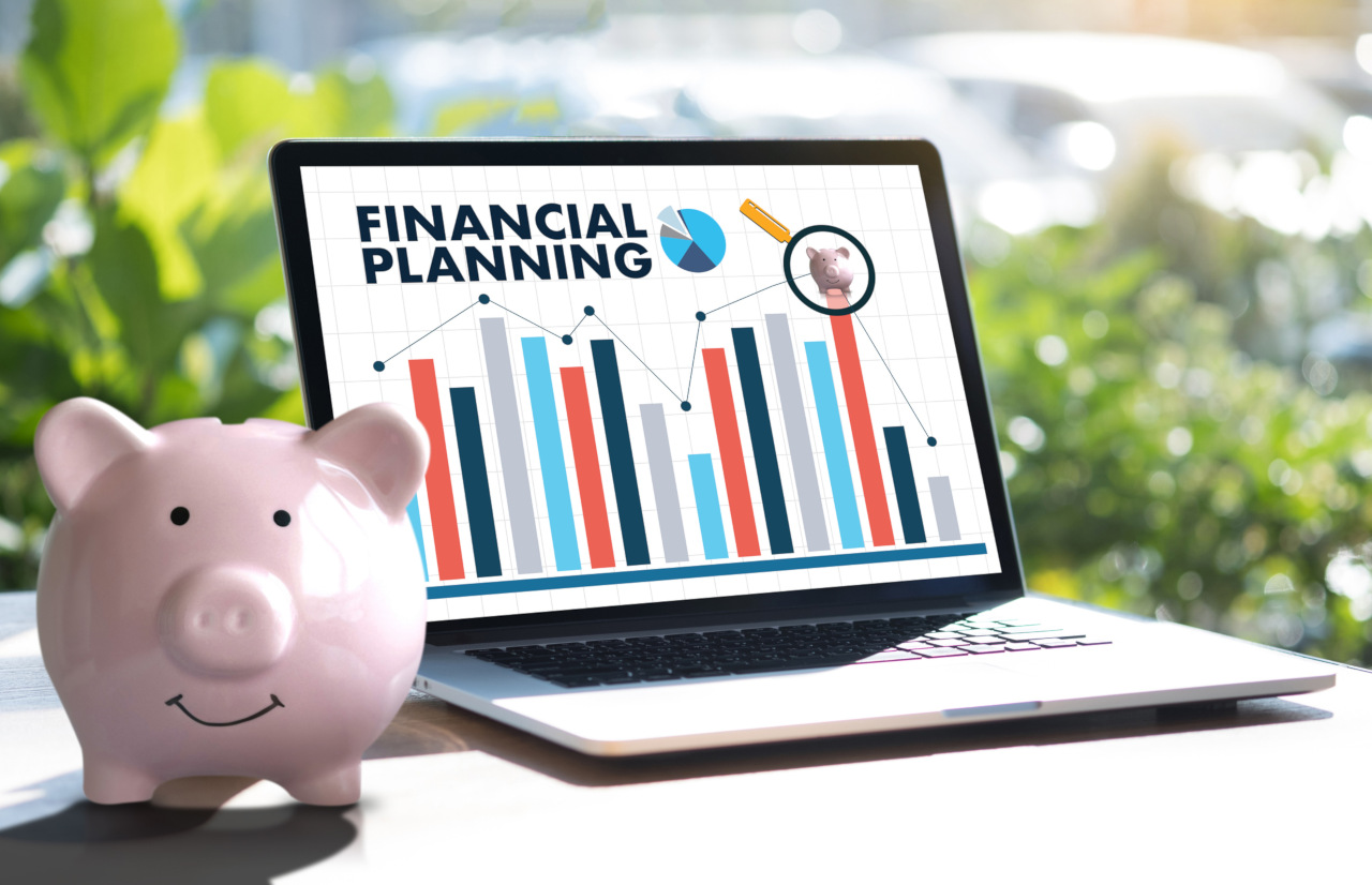 Smiling piggy bank with laptop computer display of &quot;Financial Planning&quot;