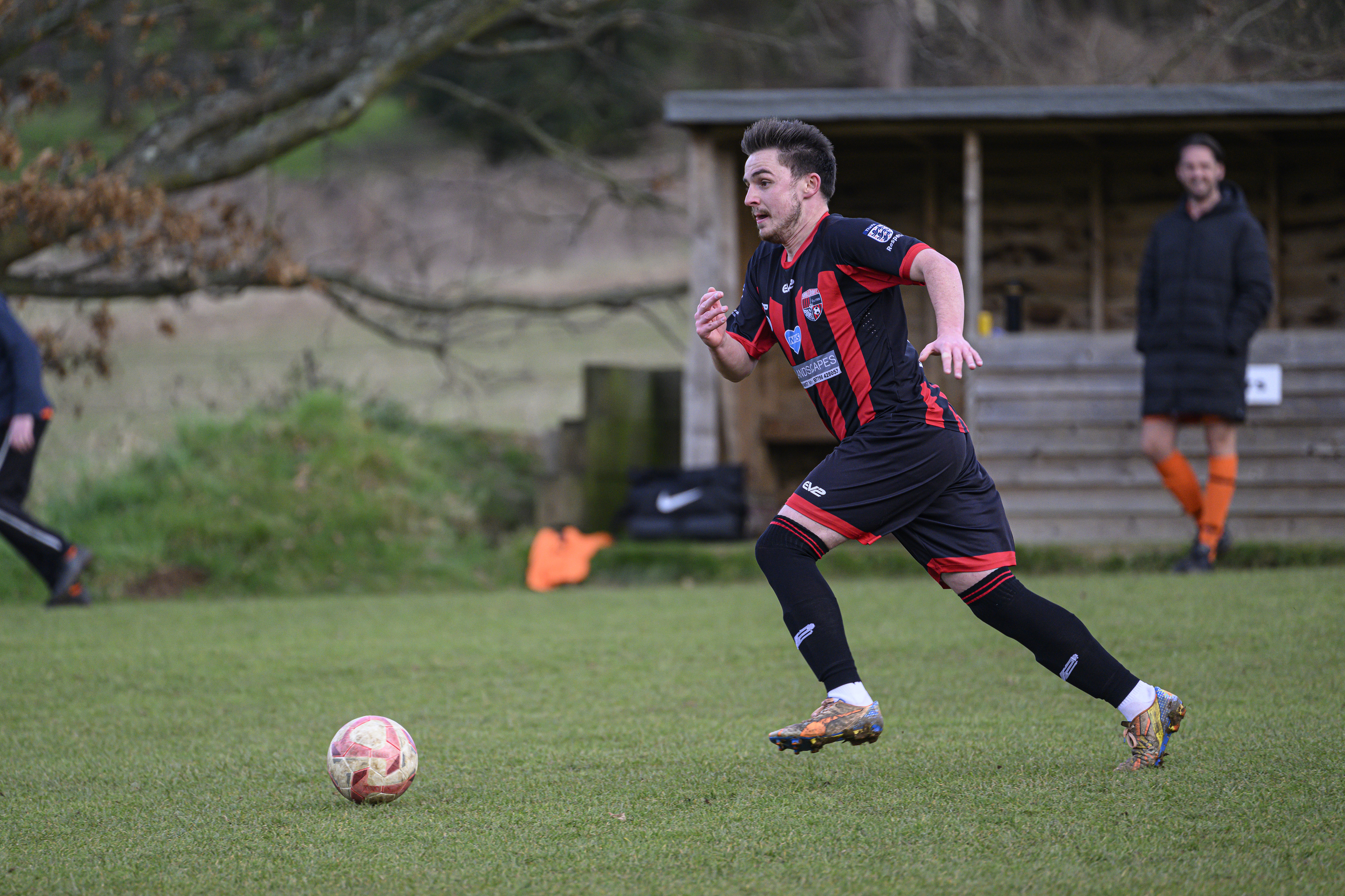 Some footballers playing in a field