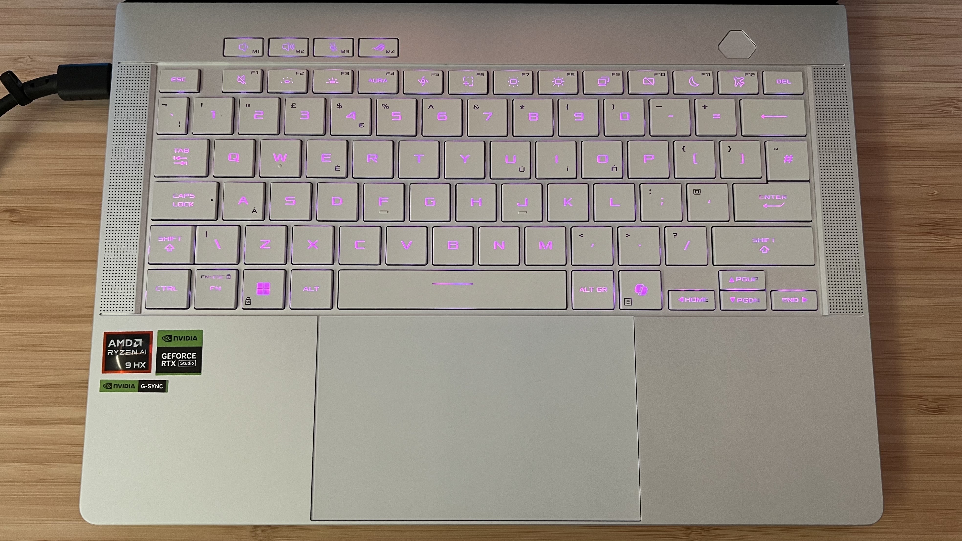Keyboard and trackpad of Asus ROG Zephyrus G14 gaming laptop with pink RGB lighting