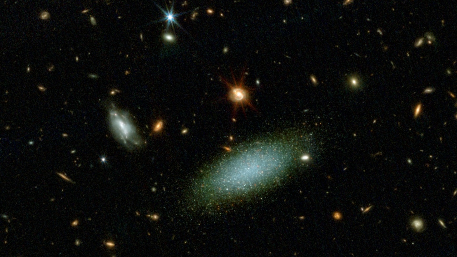 an image of outer space showing a collection of galaxies that are all different colors, shapes, and sizes