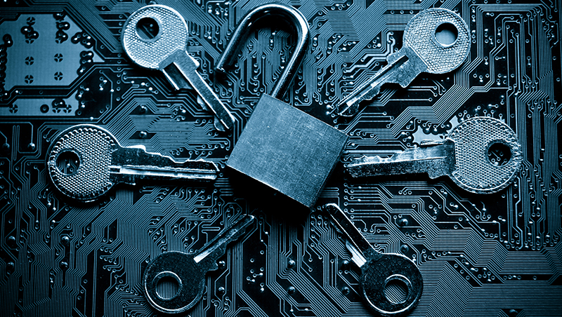 A padlock on a motherboard surrounded by keys