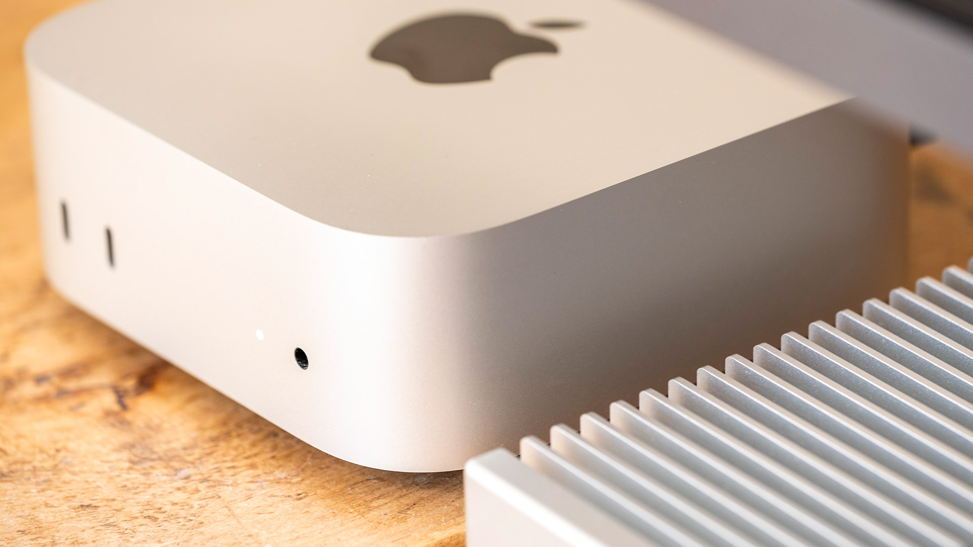 OWC Express 1M2 SSD enclosure on a table beside Apple Mac mini M4
