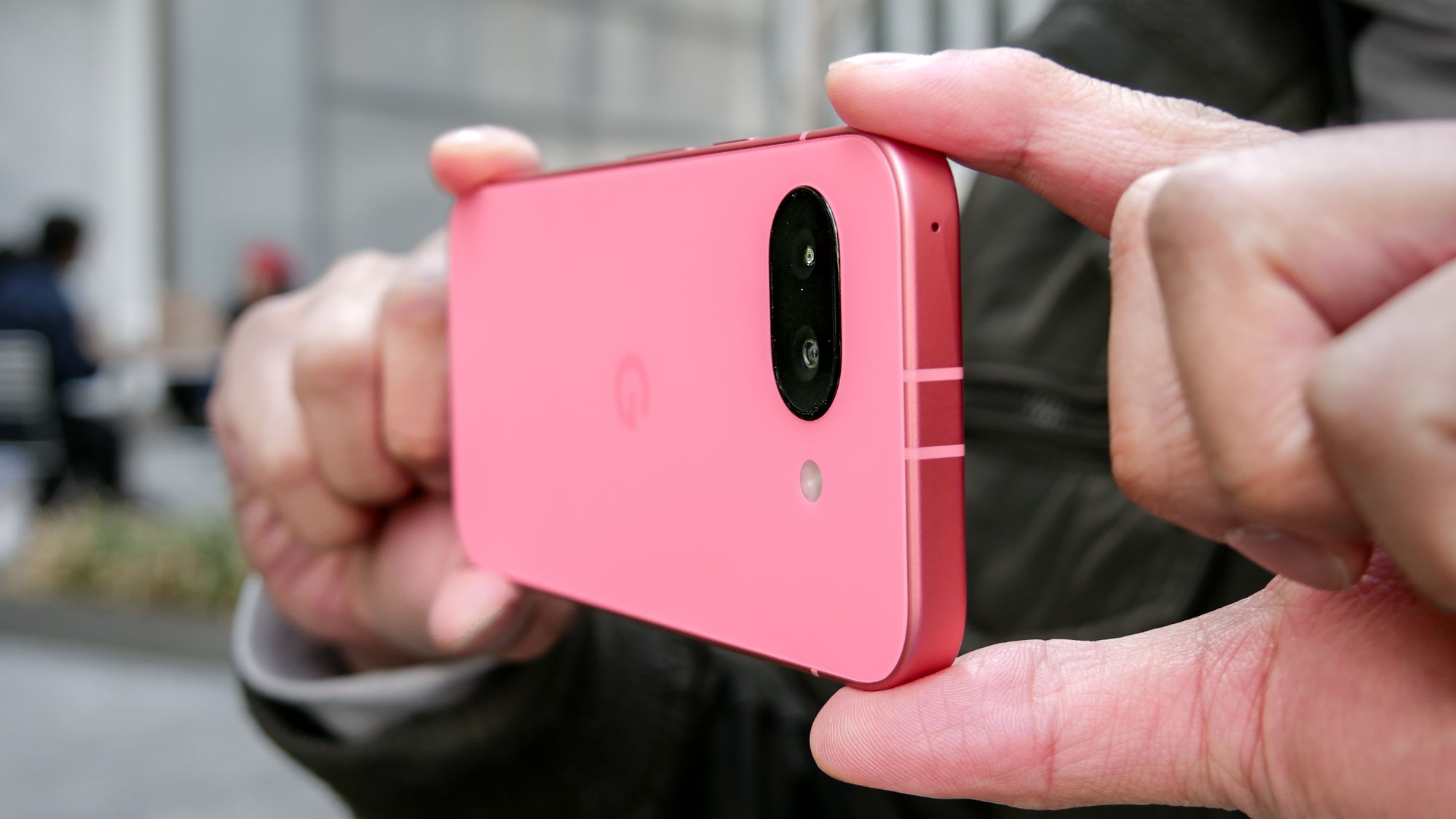 Google Pixel 9a held in the hand.