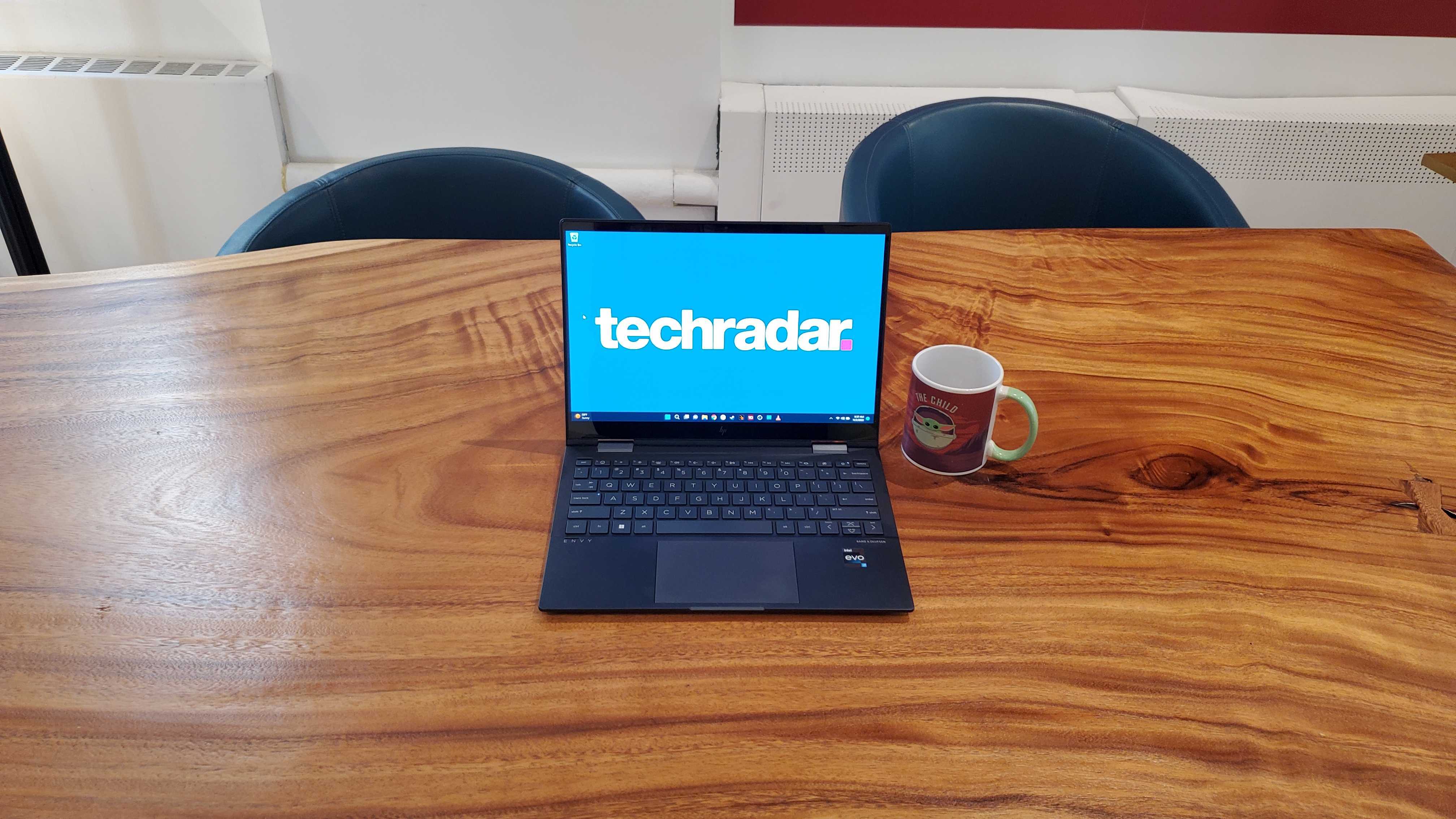 black laptop sitting on wooden desk