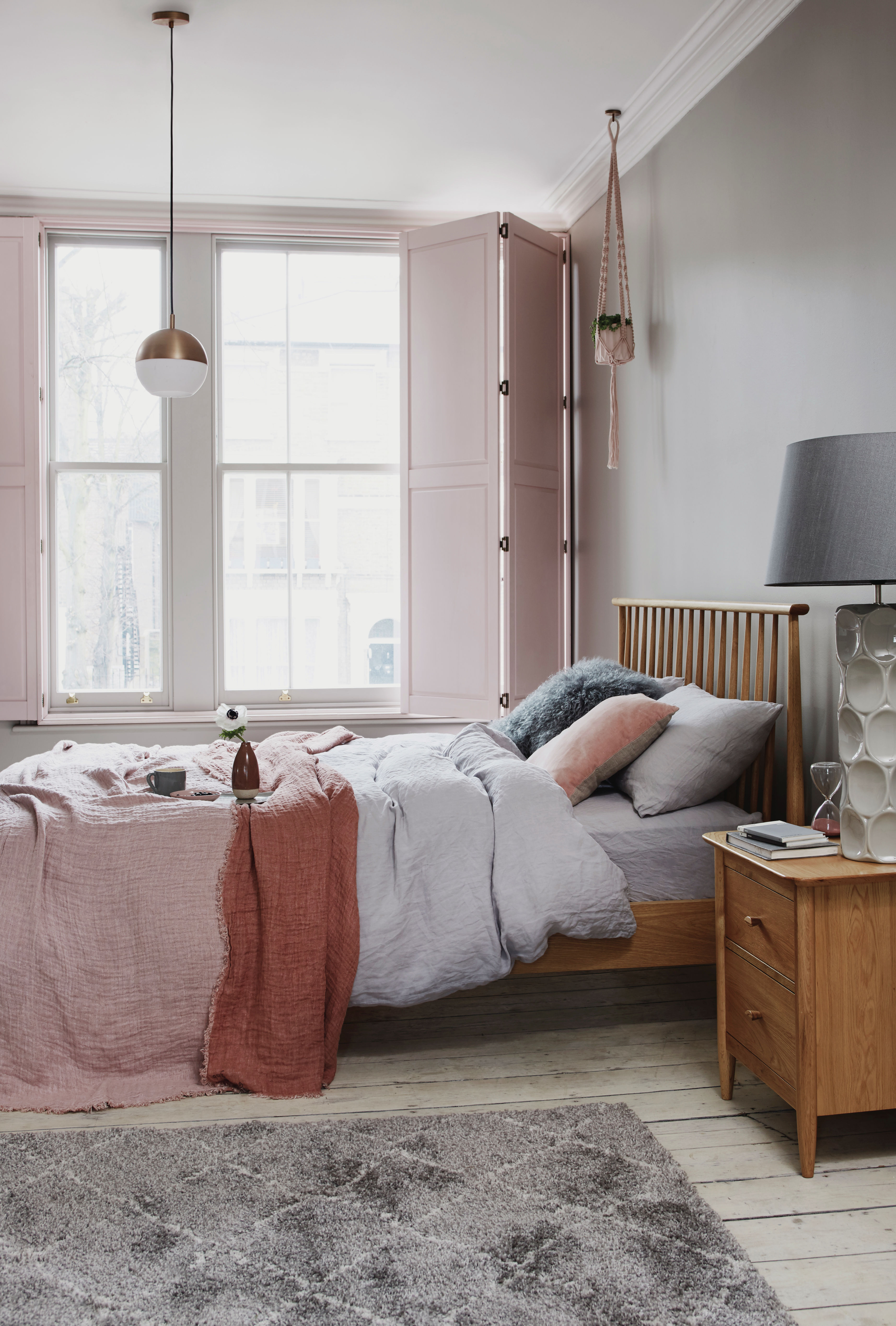 blush tones in a bedroom with a gray rug and big windows. Bedroom ideas by Furniture Village