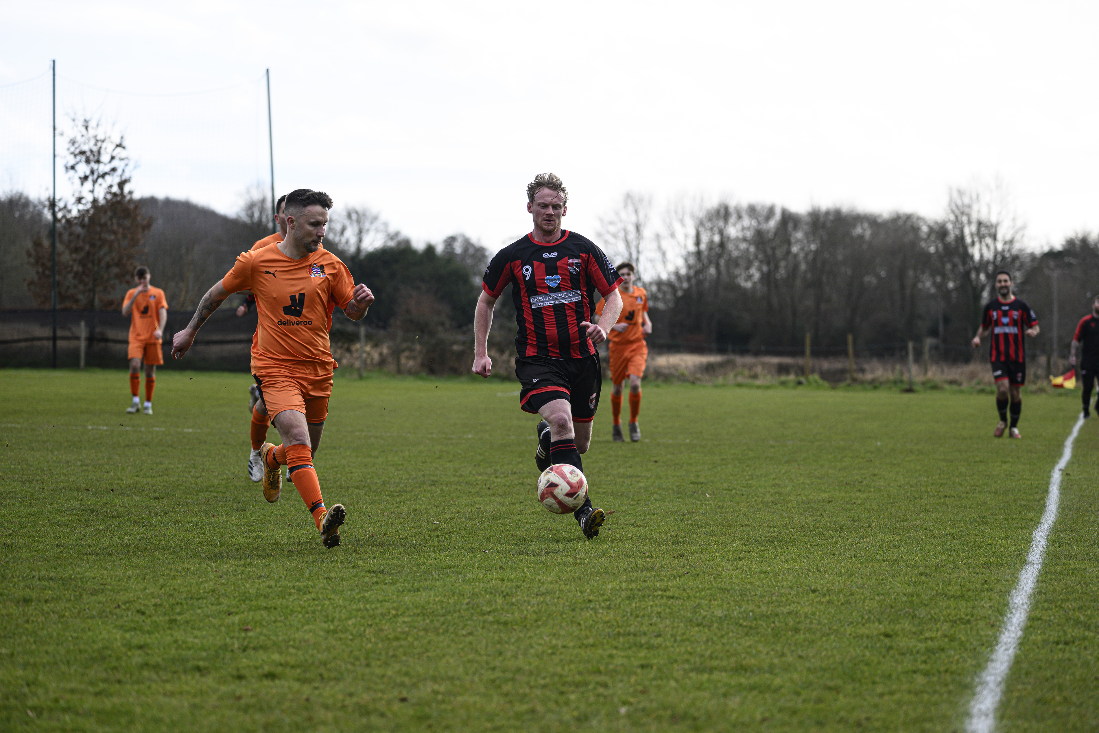 Some footballers playing in a field