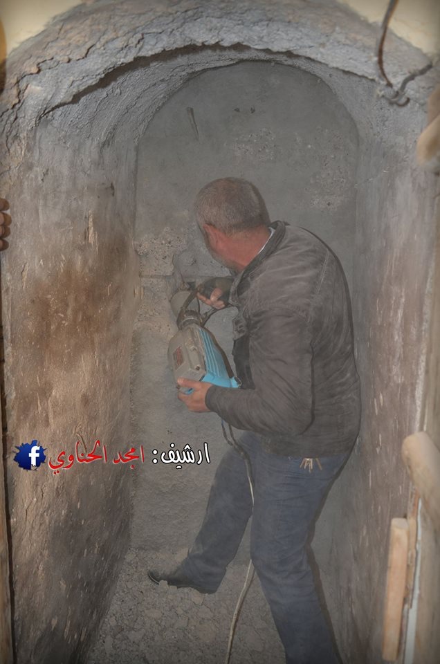 A member of the Iraqi Christian community helping to break down a wall in the Mar Behnam monastery where ancient texts were hidden.