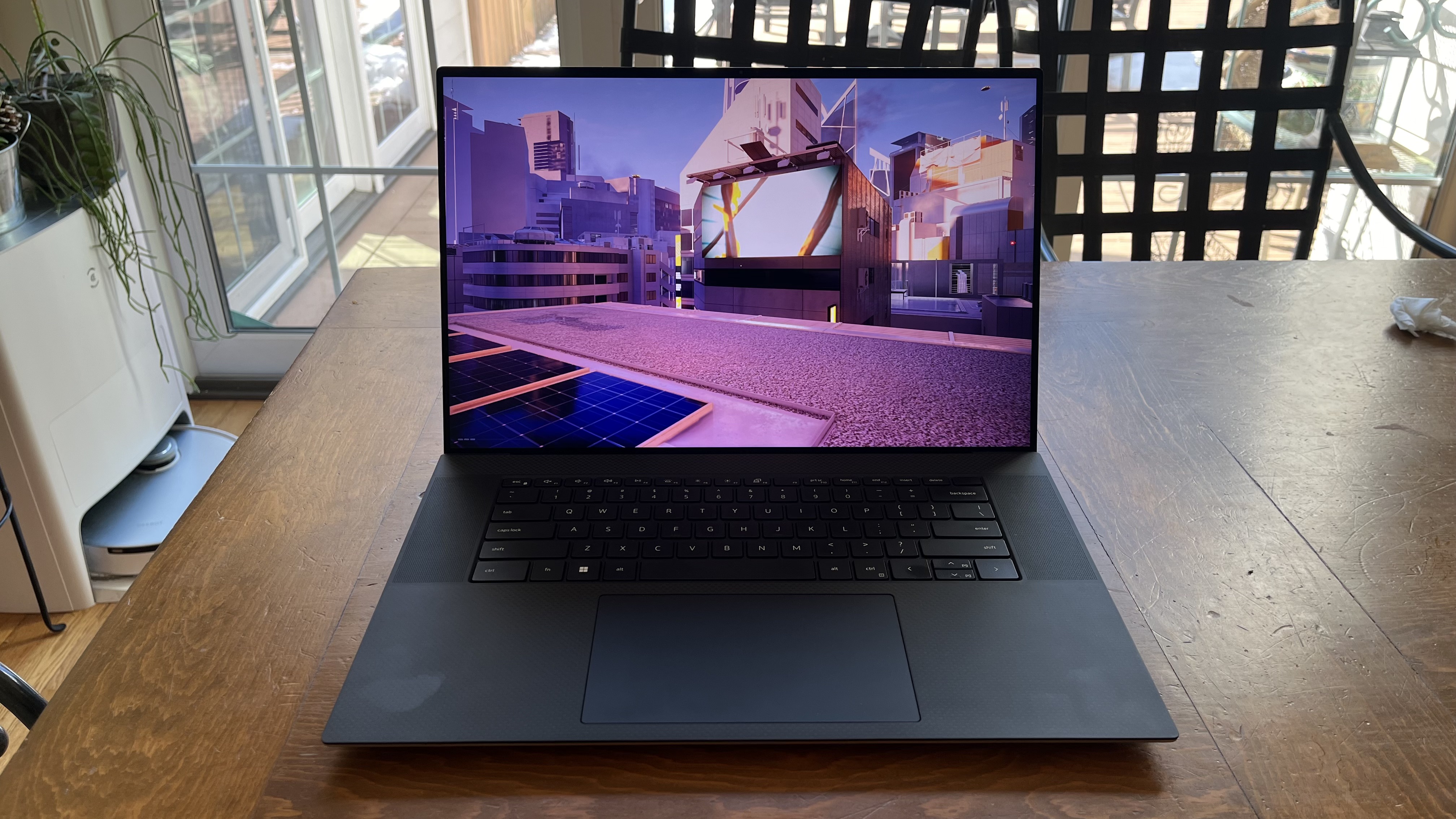 Dell XPS 17 laptop in use on a wooden desk