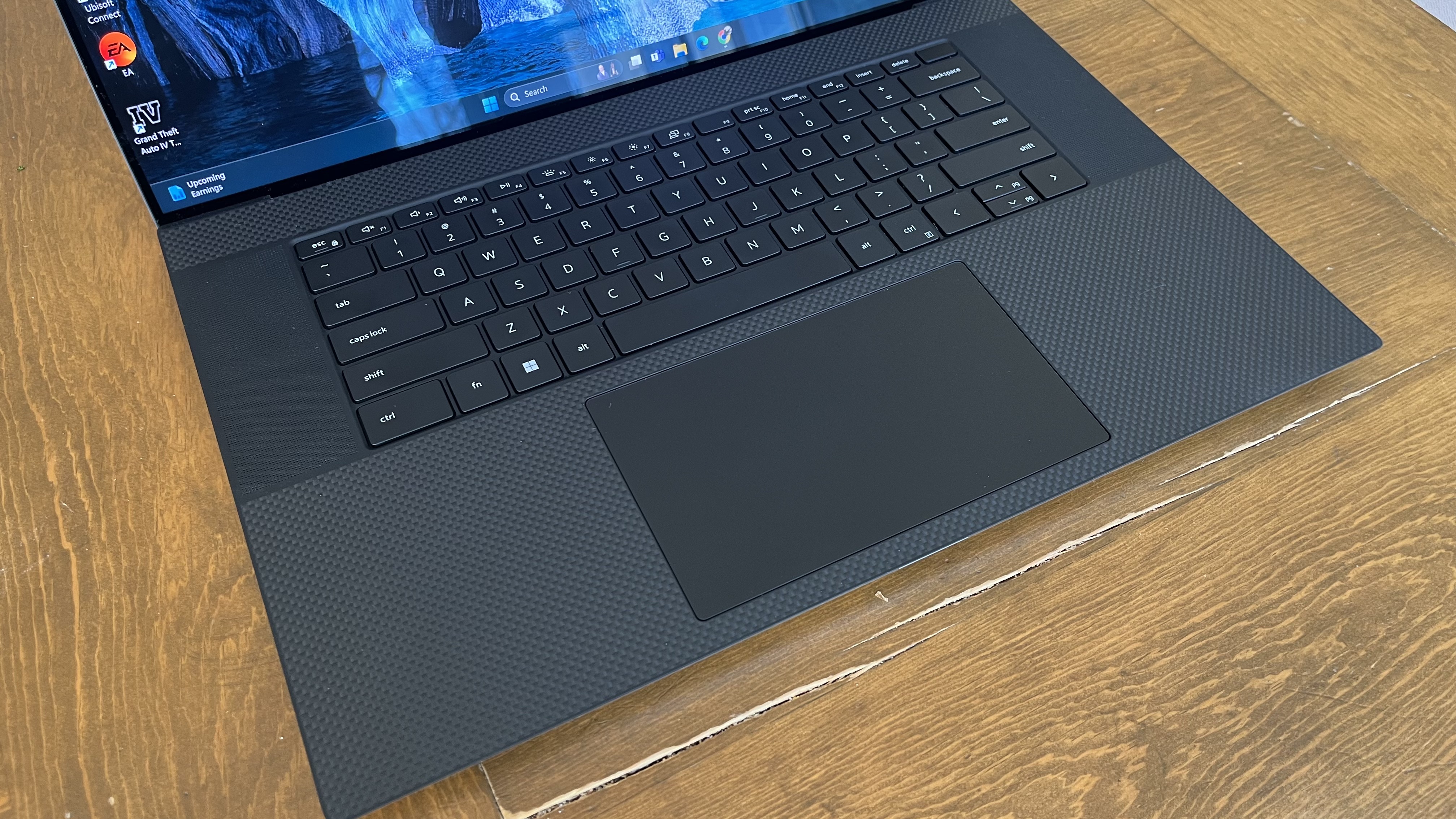 Dell XPS 17 laptop in use on a wooden desk